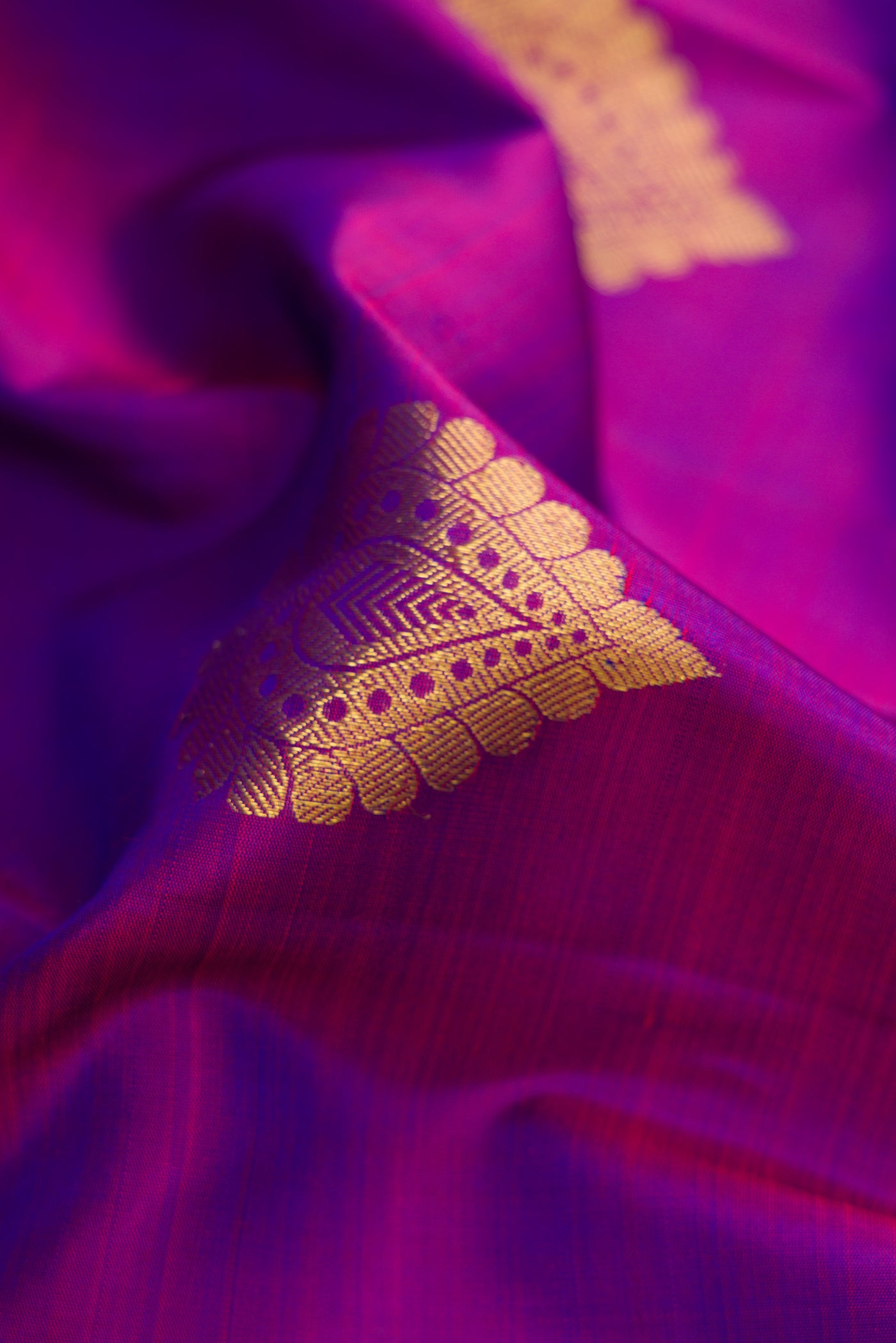 Close up of Purple Dual Tone Kanjivaram Silk Saree with Zari Butta on the body and Zari Border.  displaying folds