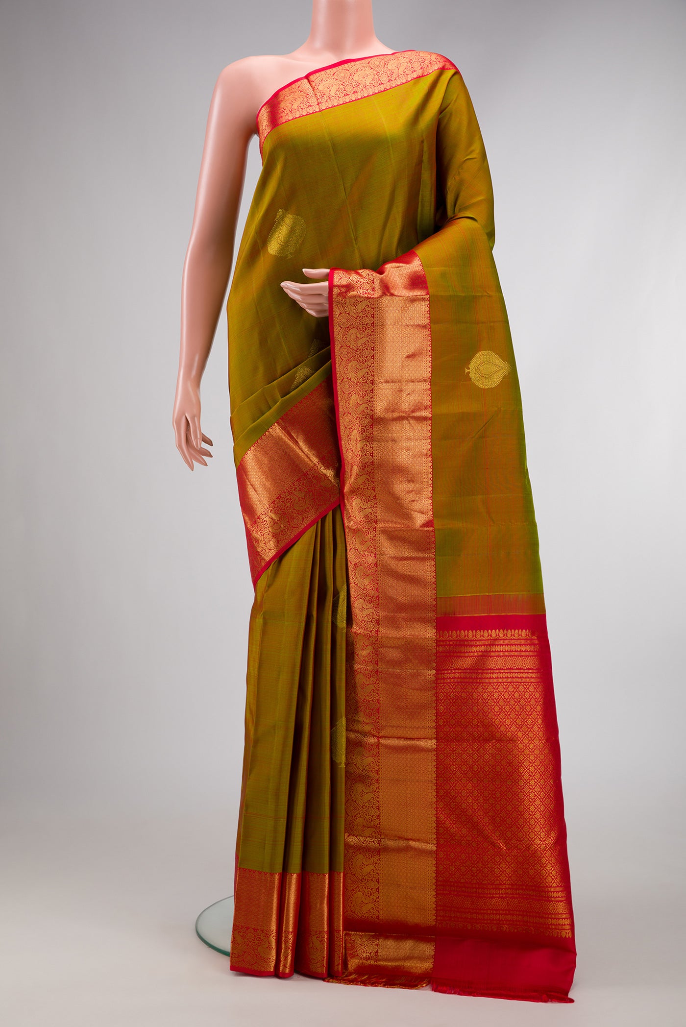 Mehandi Green Dual Tone Kanjivaram Silk Saree with Zari Butta on the body and Zari Border.  displayed on a mannequin