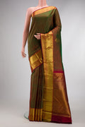 Mehandi Green Dual Tone Kanjivaram Silk Saree with Zari Butta on the body and Zari Border.  displayed on a mannequin