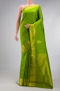 Parrot Green Kanjivaram Silk Saree with Zari Butta on the body and Zari Border.  displayed on a mannequin
