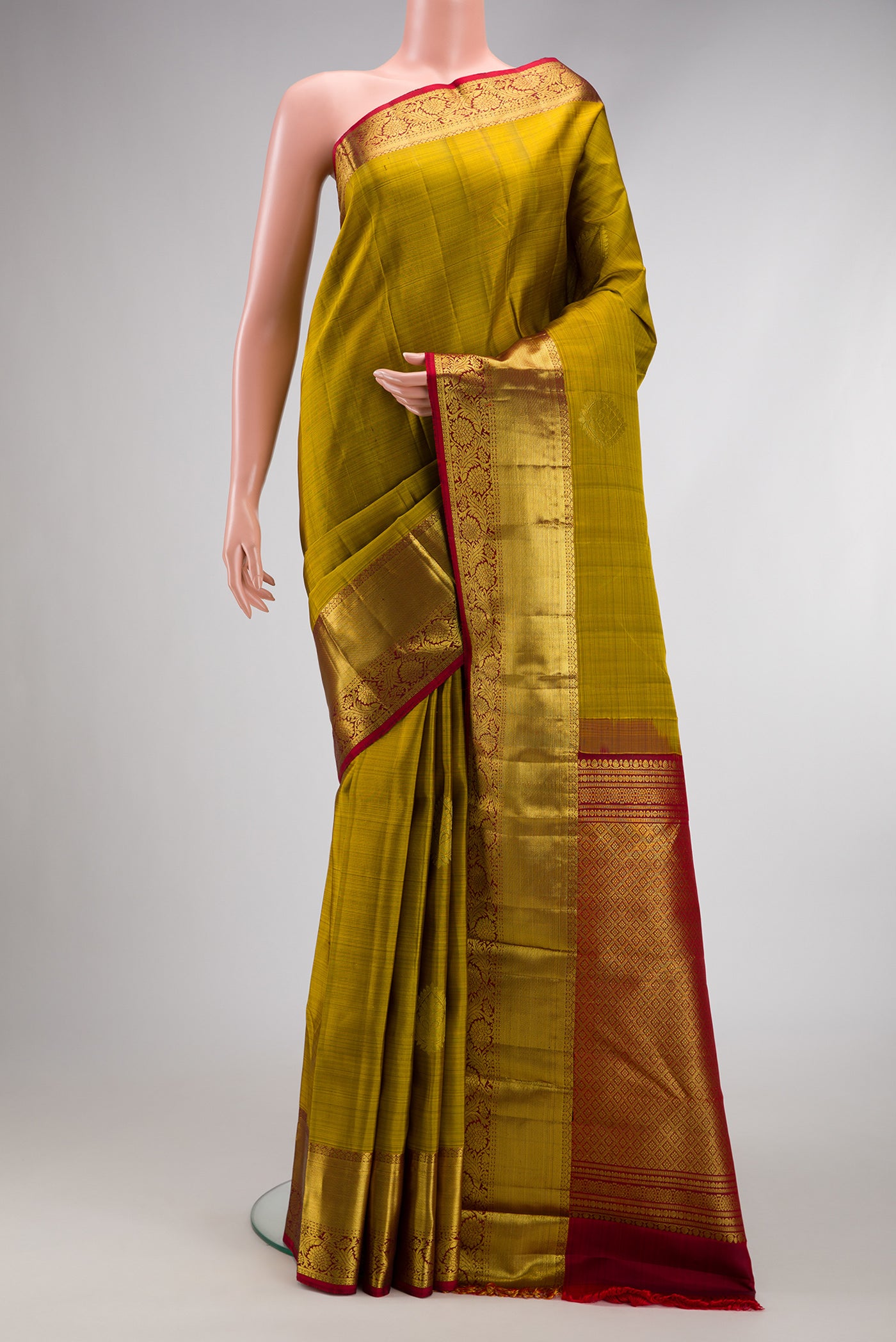 Mehandi Green Dual Tone Kanjivaram Silk Saree with Zari Butta on the body and Zari Border.  displayed on a mannequin
