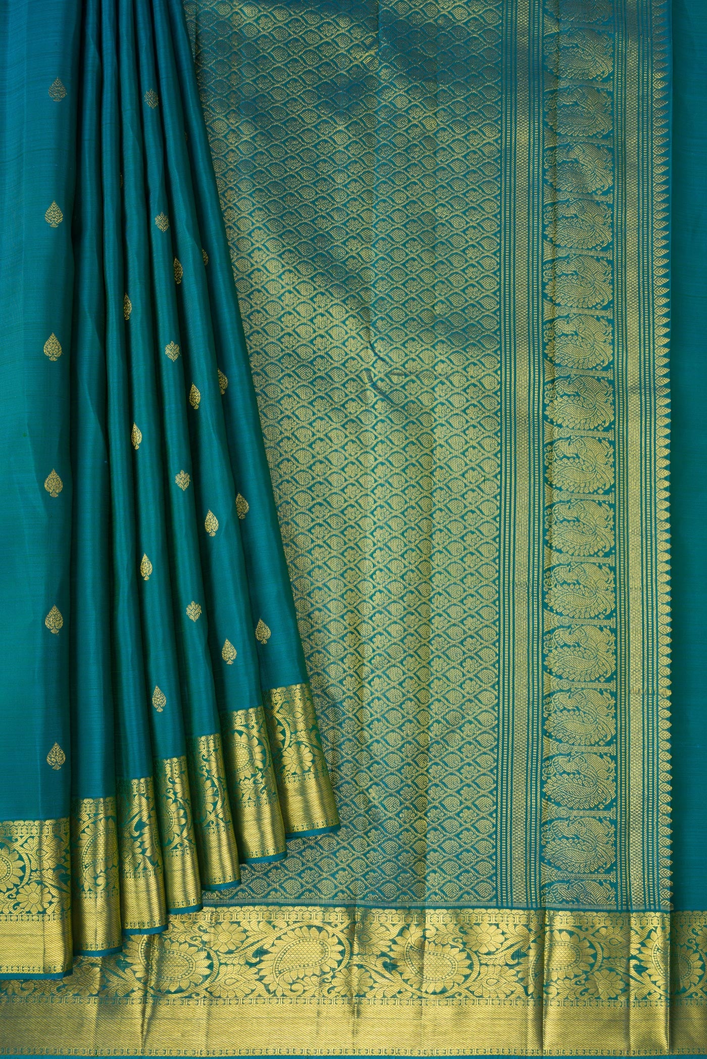 Pleats and pallu of Teal Dual Tone Kanjivaram Silk Saree with Zari Butta on the body and Zari Border. 