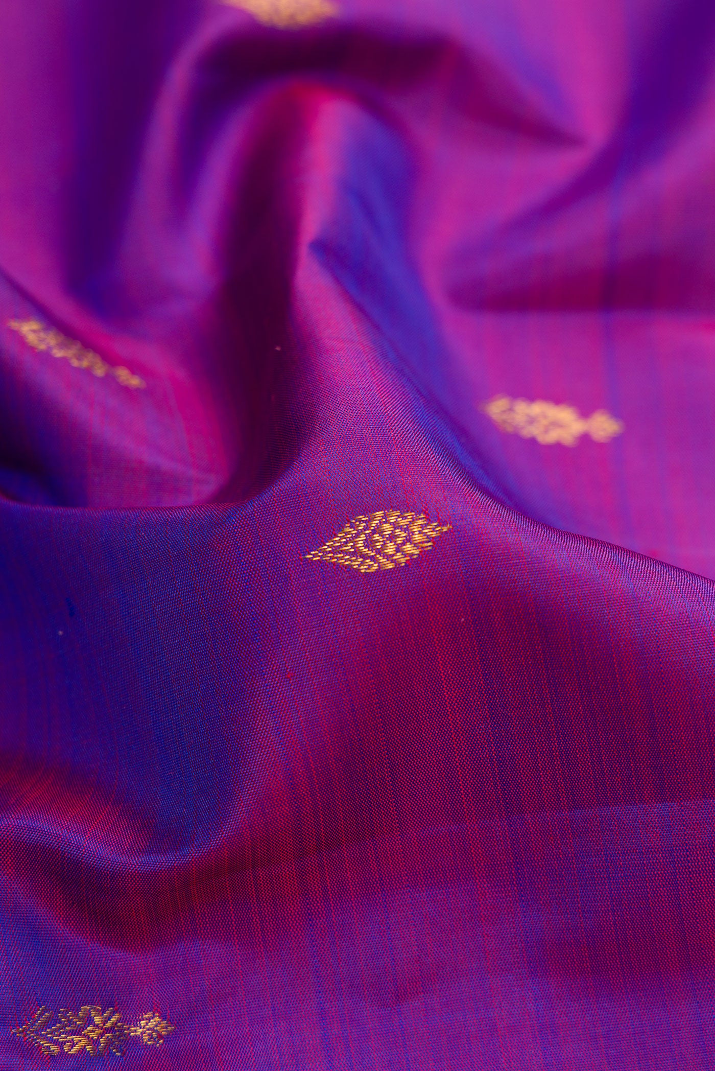 Close up of Purple Dual Tone Kanjivaram Silk Saree with Zari Butta on the body and Zari Border.  displaying folds