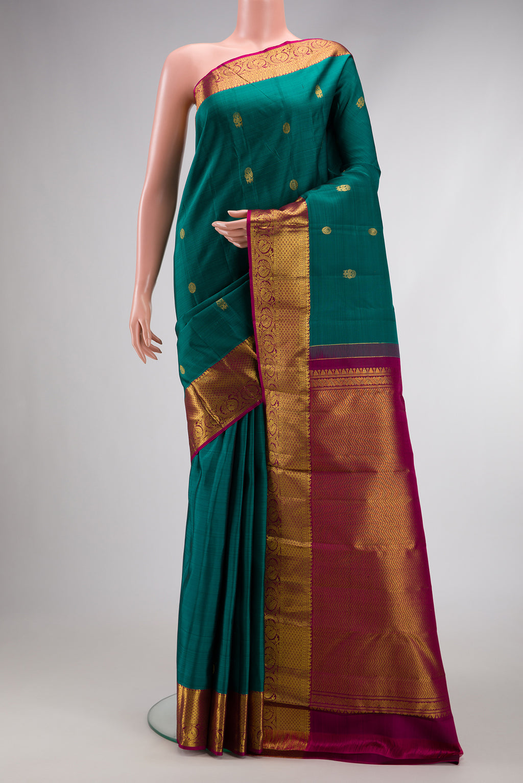 Green Dual Tone Kanjivaram Silk Saree with Zari Butta on the body and Zari Border.  displayed on a mannequin