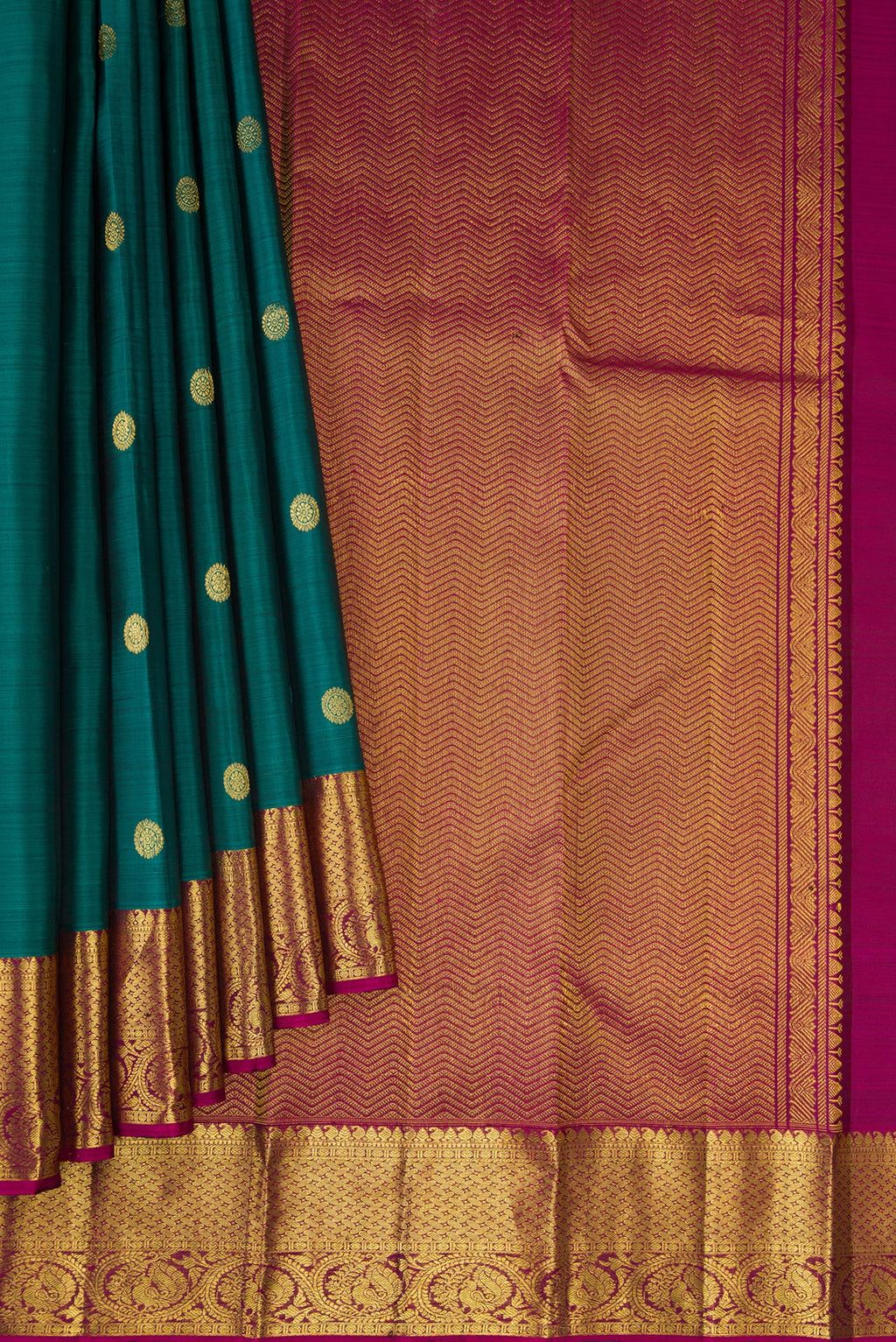 Pleats and pallu of Green Dual Tone Kanjivaram Silk Saree with Zari Butta on the body and Zari Border. 