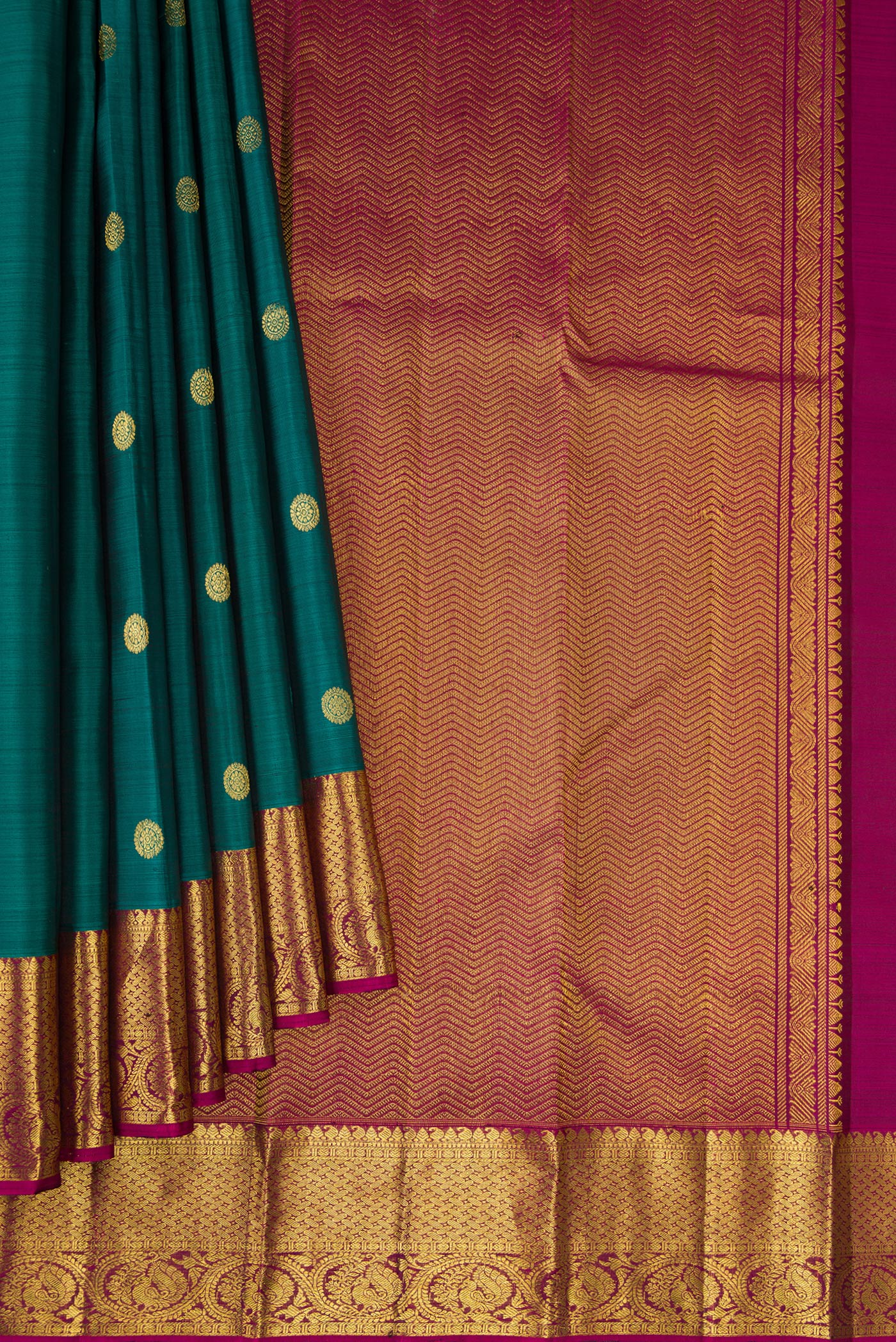 Pleats and pallu of Green Dual Tone Kanjivaram Silk Saree with Zari Butta on the body and Zari Border. 