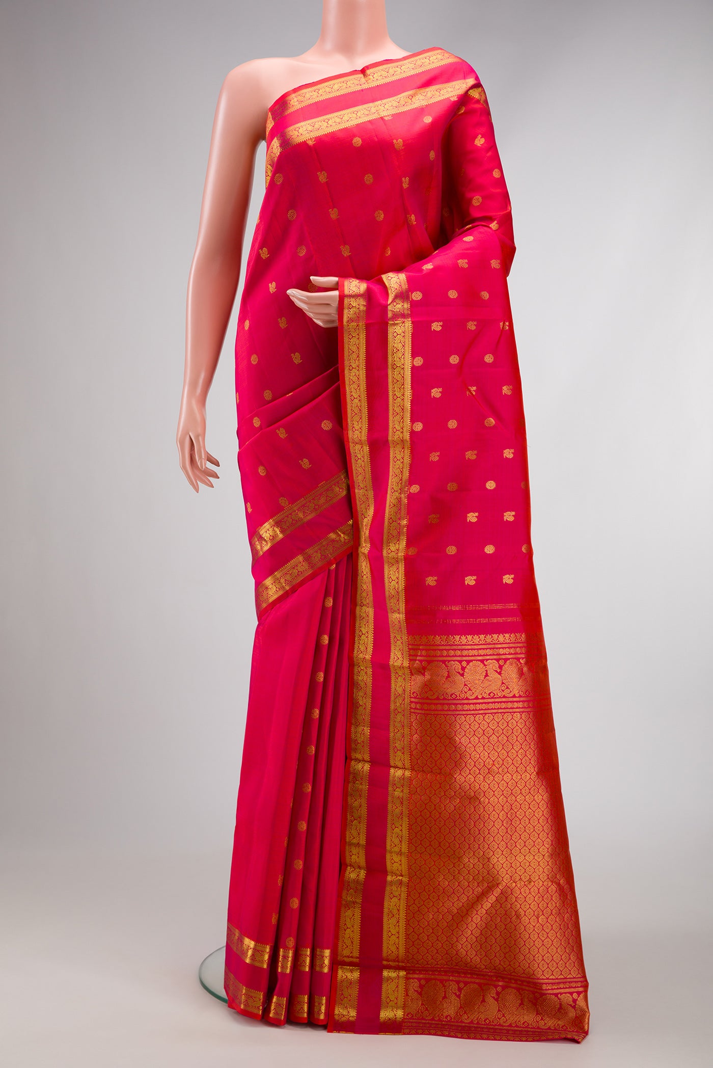Pink with Red Color Kanjivaram Silk Saree with Zari Butta on the body and Zari Border.  displayed on a mannequin