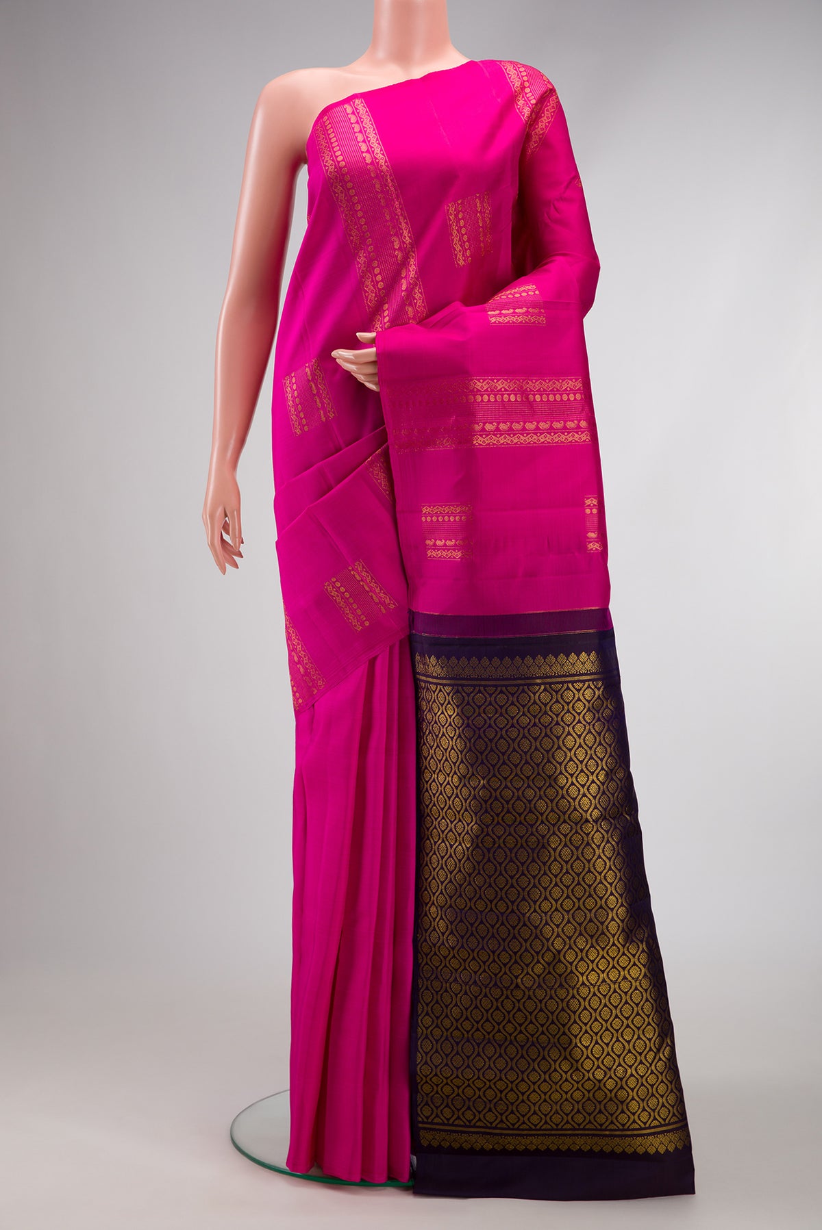 Dark Pink Kanjivaram Silk Saree with Zari Butta on the body and Without Border.  displayed on a mannequin
