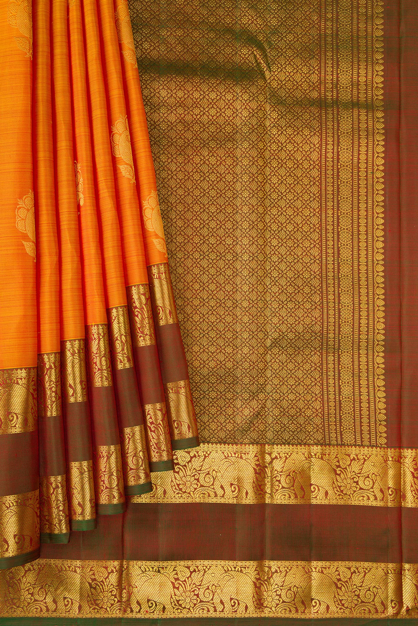 Pleats and pallu of Mustard Dual Tone Kanchipuram Silk Saree with Zari Butta on the body and Zari Border. 