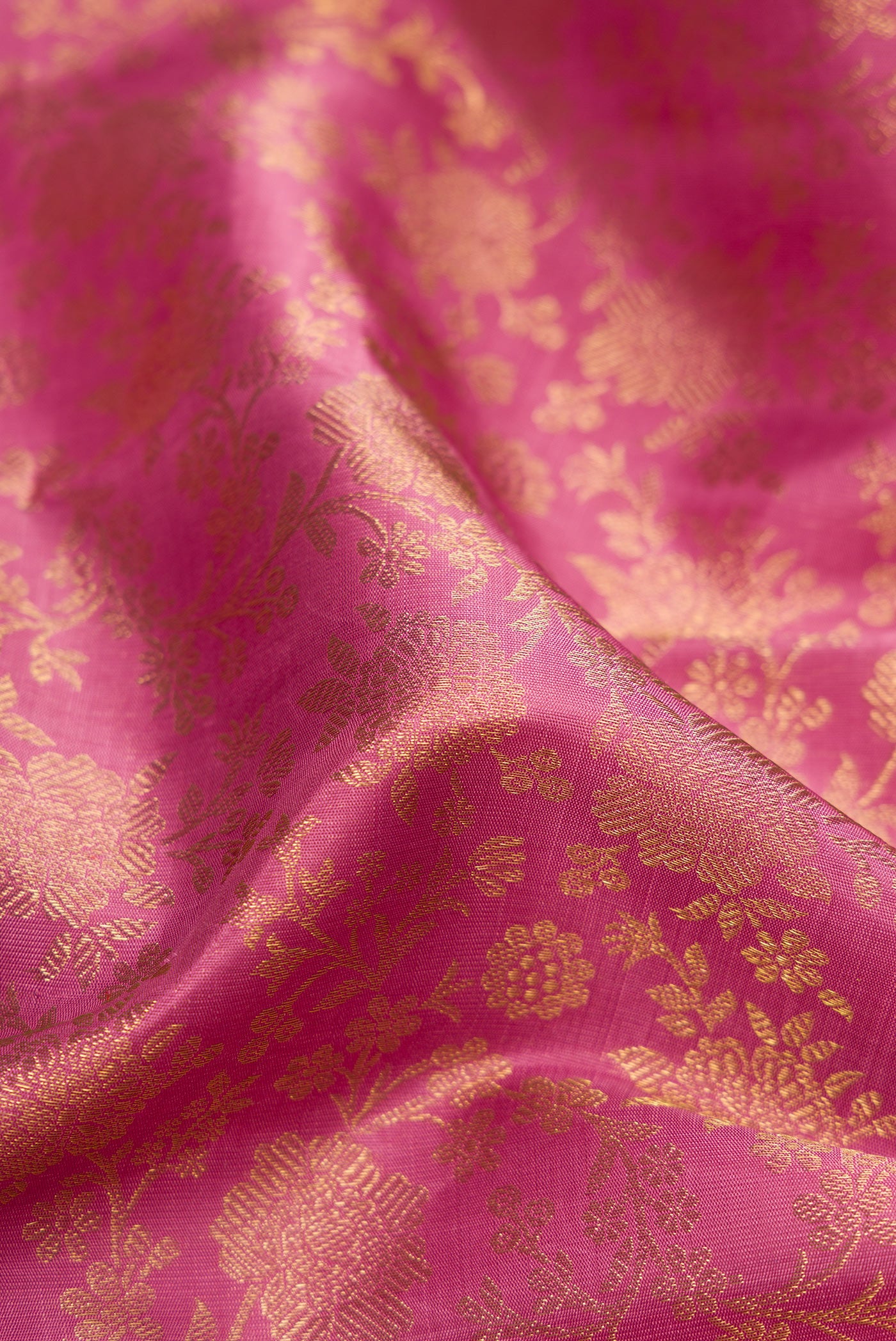 Close up of Pure Silk Pure Zari Pink Dual Tone Kanjivaram Saree with Zari Brocade on the body and Zari Border.  displaying folds