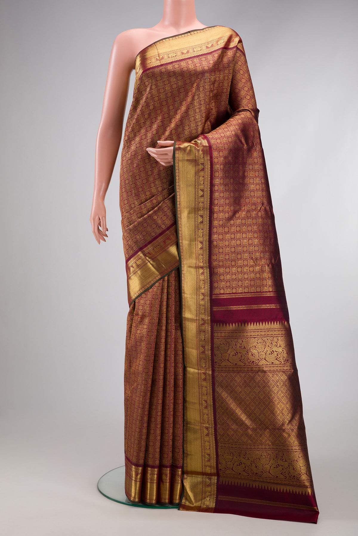 Pure Silk Pure Zari Maroon Kanjivaram Saree with Zari Brocade on the body and Zari Border.  displayed on a mannequin