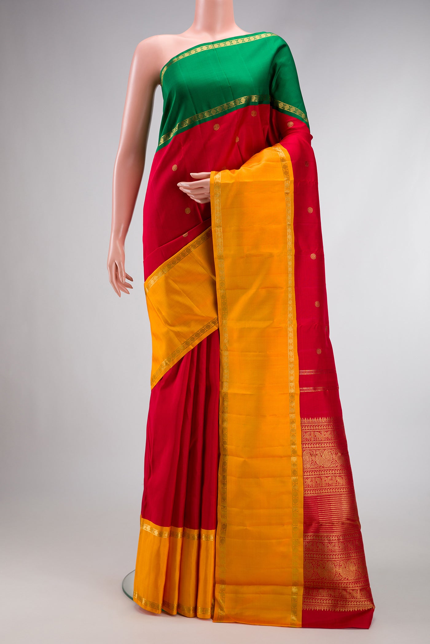 Red Dual Tone Kanjivaram Silk Saree with Zari Butta on the body and Ganga Jamuna Border.  displayed on a mannequin