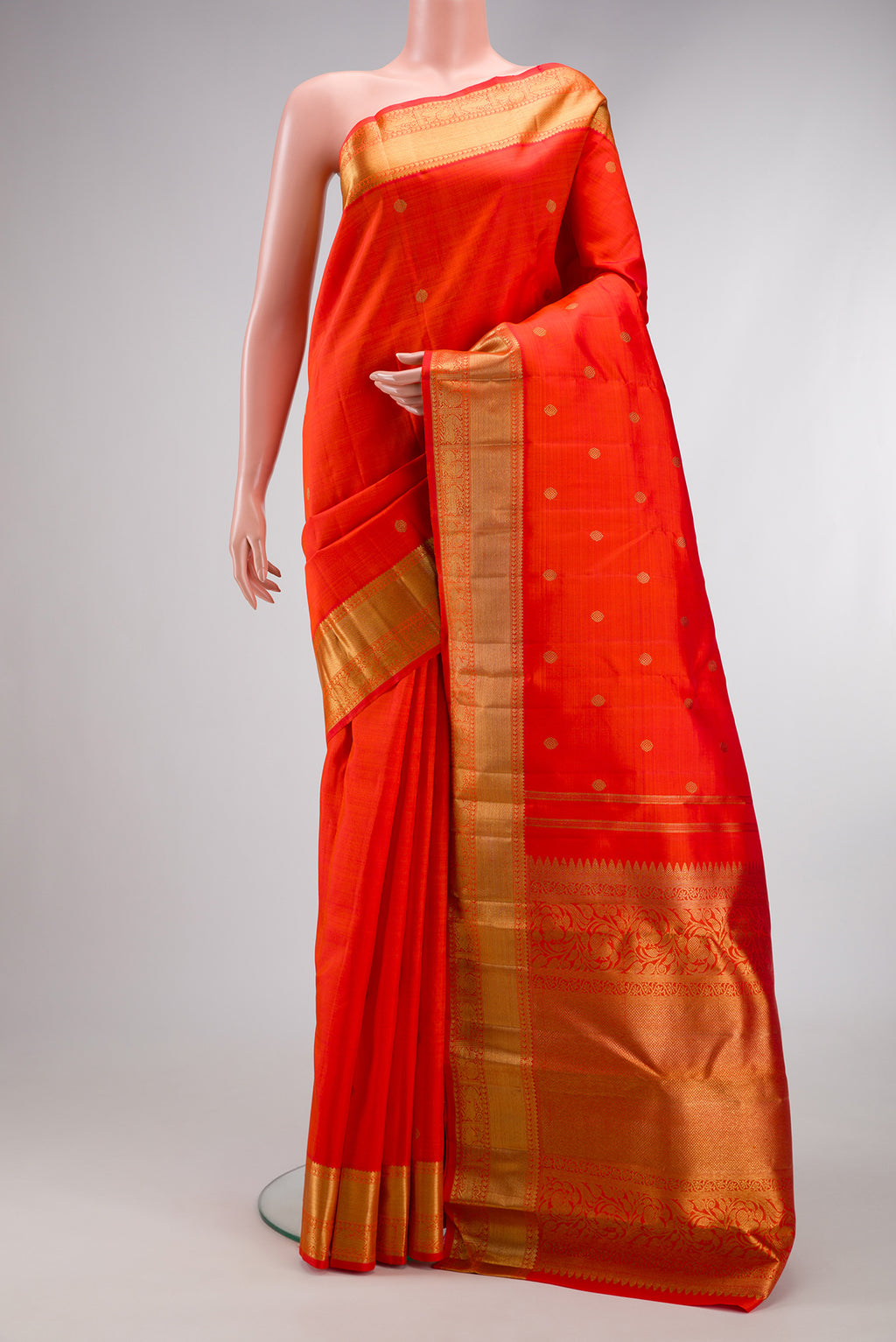 Pure Silk Pure Zari Orange Dual Tone Kanjivaram Saree with Zari Butta on the body and Zari Border.  displayed on a mannequin