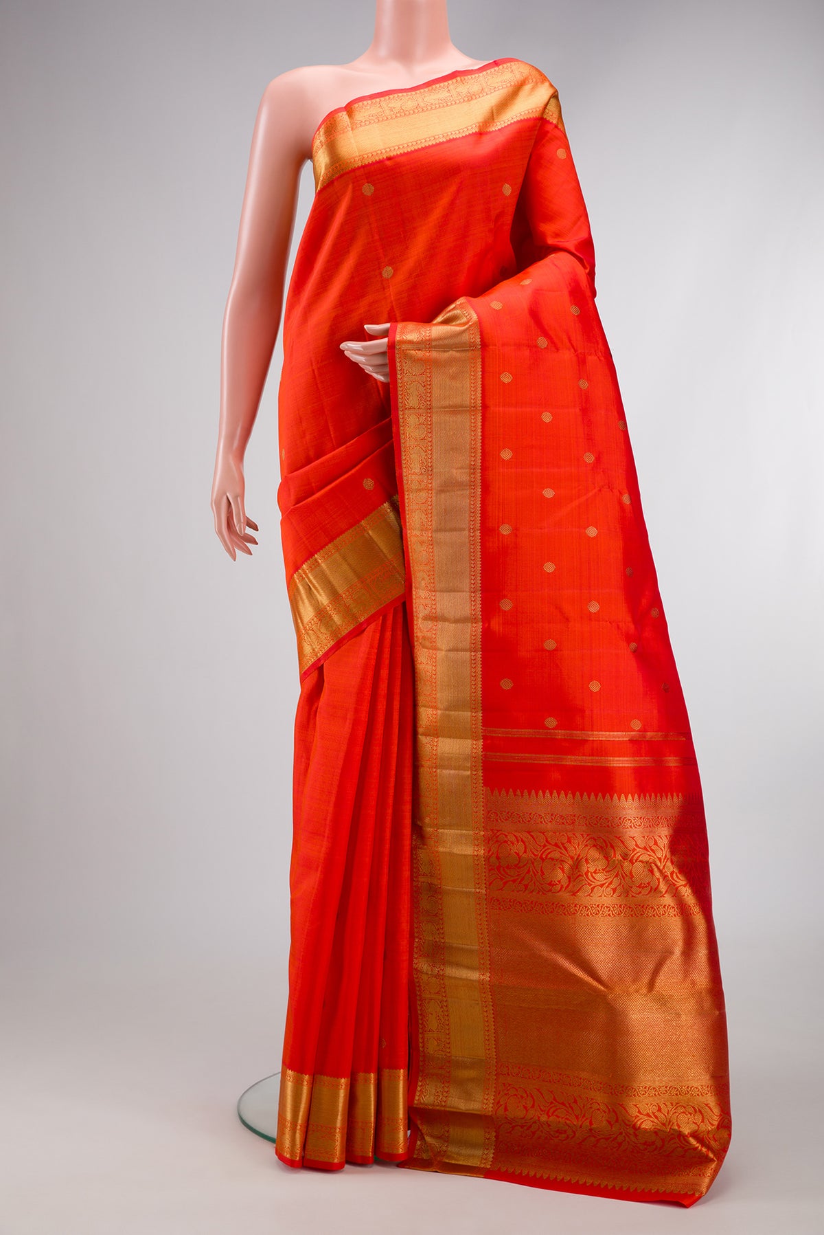 Pure Silk Pure Zari Orange Dual Tone Kanjivaram Saree with Zari Butta on the body and Zari Border.  displayed on a mannequin