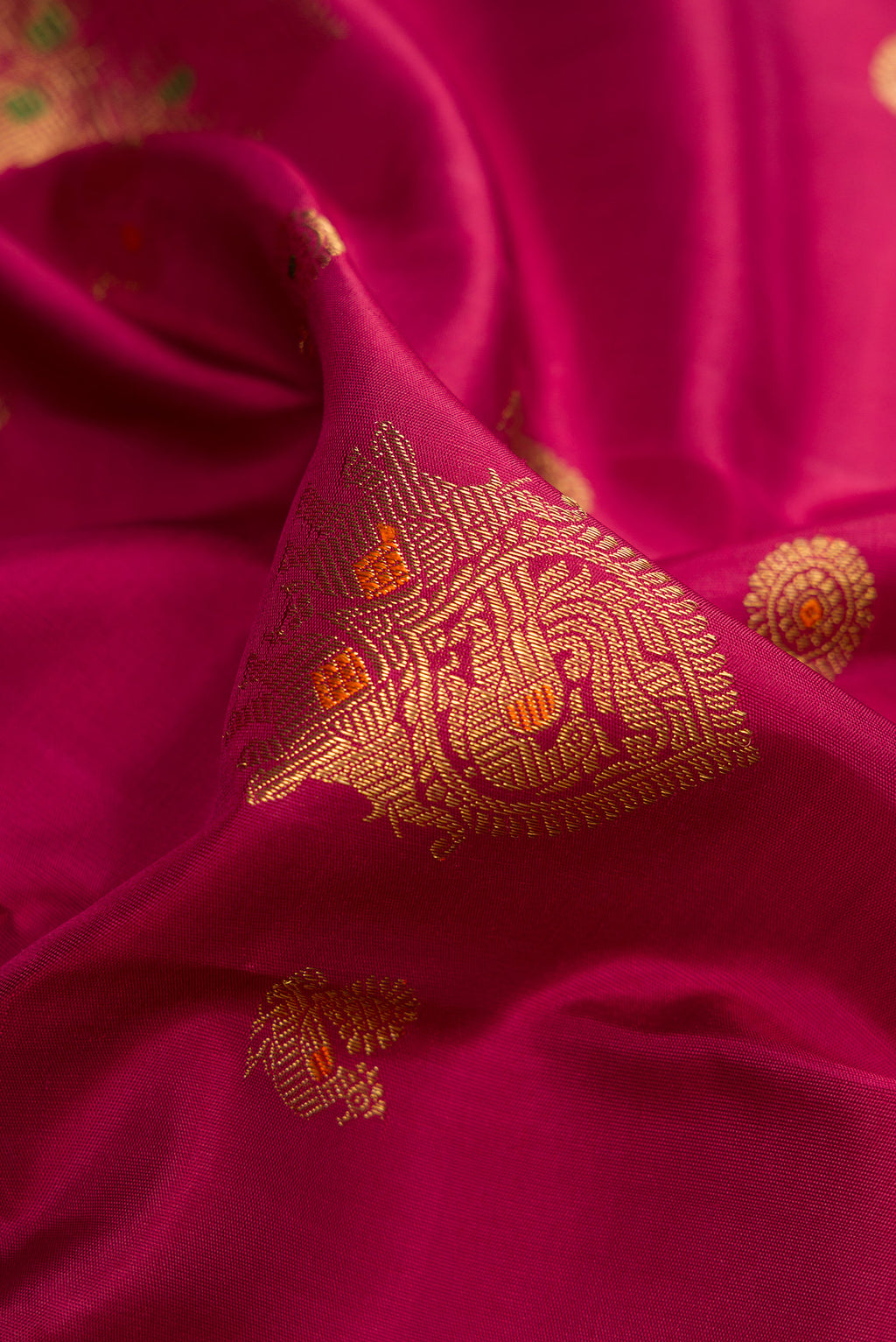 Close up of Pure Silk Pure Zari Dark Mauve Dual Tone Kanjivaram Saree with Zari Butta on the body and Zari Border.  displaying folds