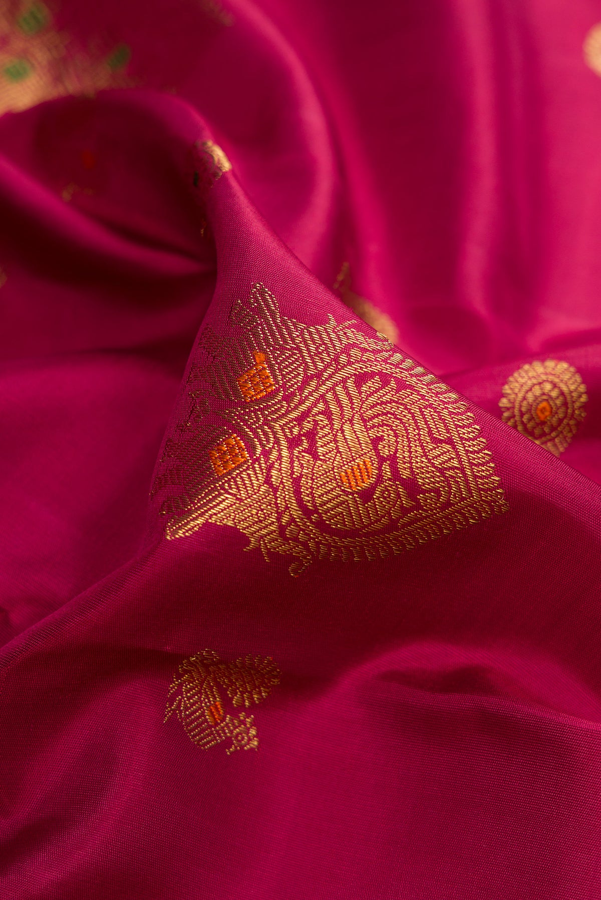 Close up of Pure Silk Pure Zari Dark Mauve Dual Tone Kanjivaram Saree with Zari Butta on the body and Zari Border.  displaying folds
