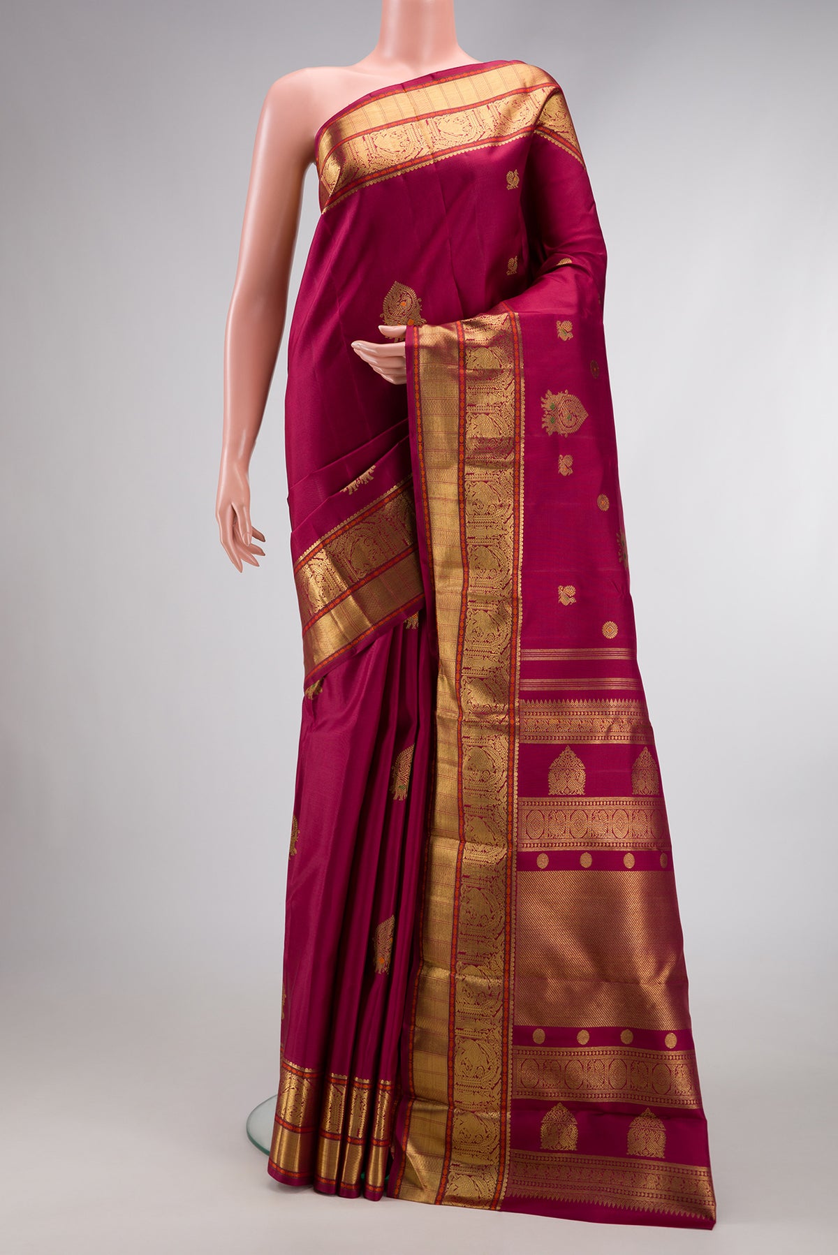 Pure Silk Pure Zari Dark Mauve Dual Tone Kanjivaram Saree with Zari Butta on the body and Zari Border.  displayed on a mannequin