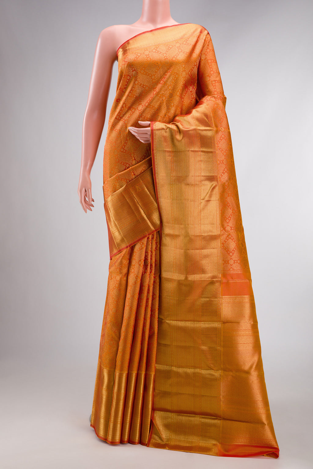 Pure Silk Pure Zari Orange Kanjivaram Saree with Zari Brocade on the body and Zari Border.  displayed on a mannequin