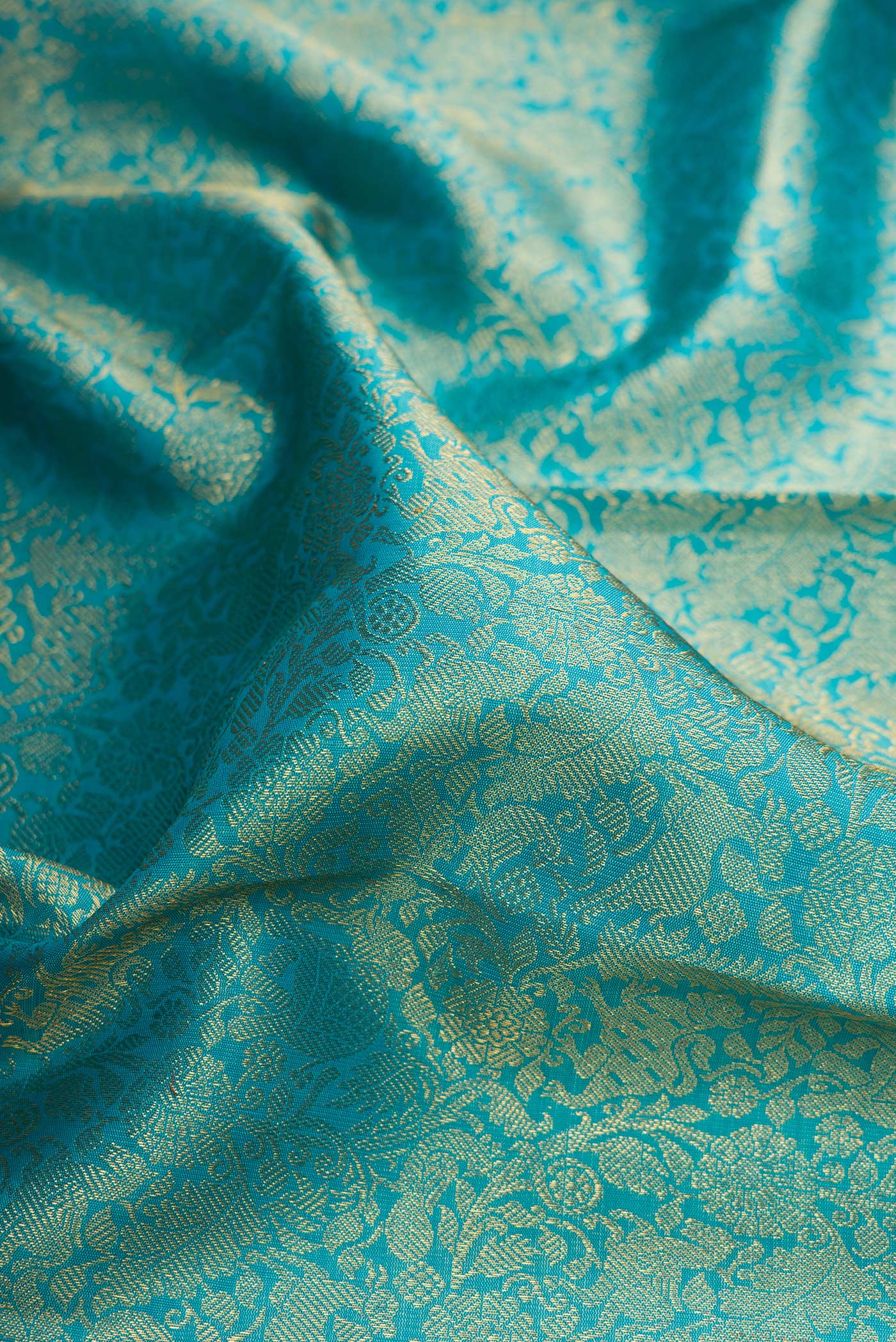Close up of Pure Silk Pure Zari Sky Blue Kanjivaram Saree with Zari Brocade on the body and Zari Border.  displaying folds
