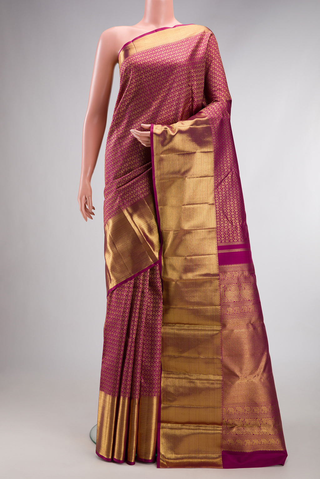 Pure Silk Pure Zari Magenta Kanjivaram Saree with Zari Brocade on the body and Zari Border.  displayed on a mannequin