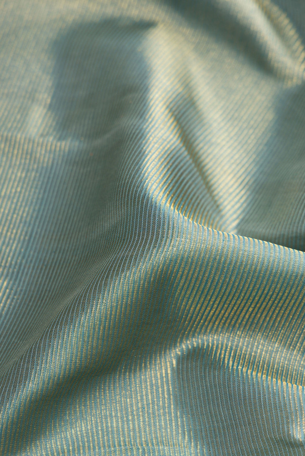 Close up of Pure Silk Pure Zari Blue Grey Dual Tone Kanjivaram Saree with Zari Brocade on the body and Zari Border.  displaying folds