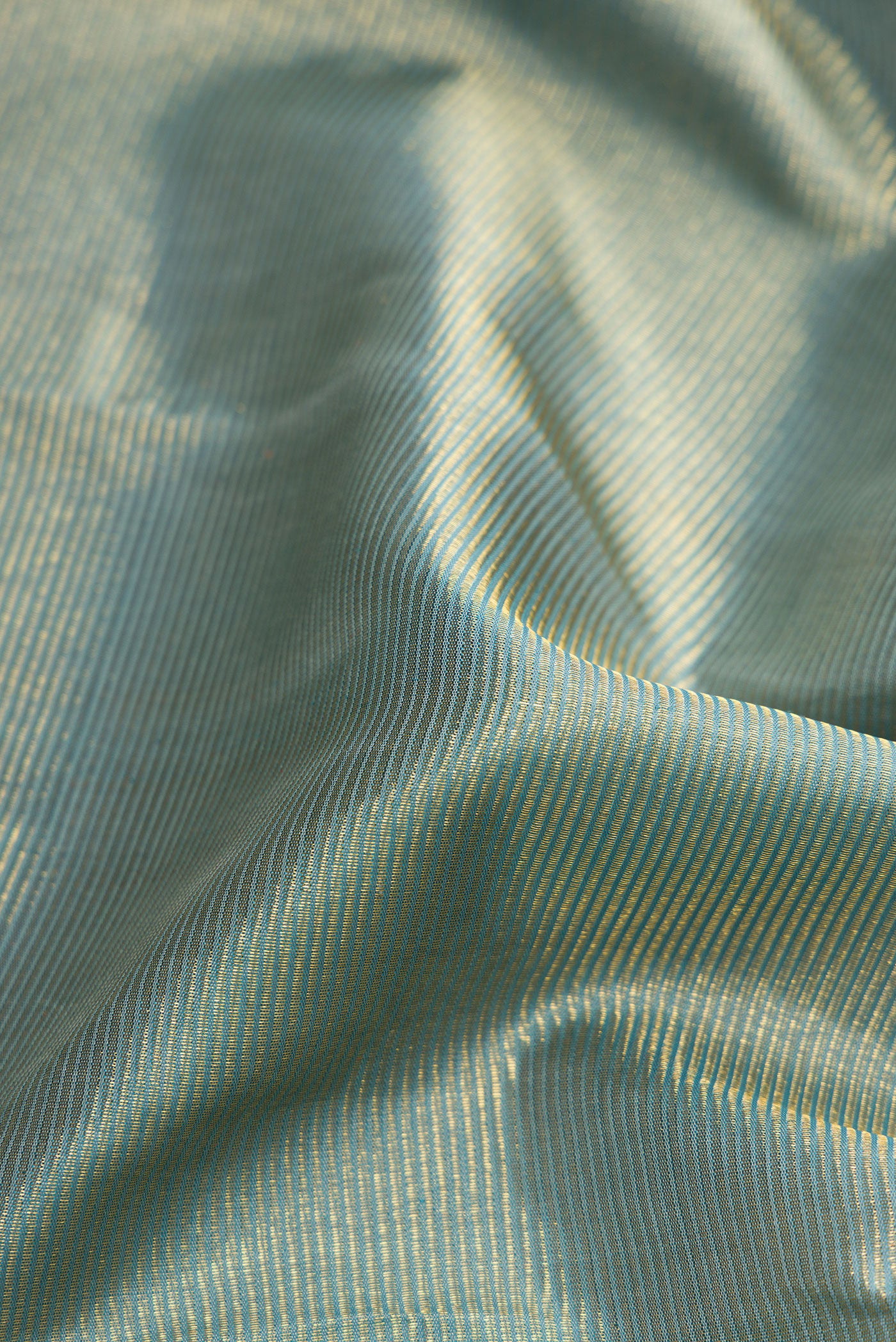 Close up of Pure Silk Pure Zari Blue Grey Dual Tone Kanjivaram Saree with Zari Brocade on the body and Zari Border.  displaying folds