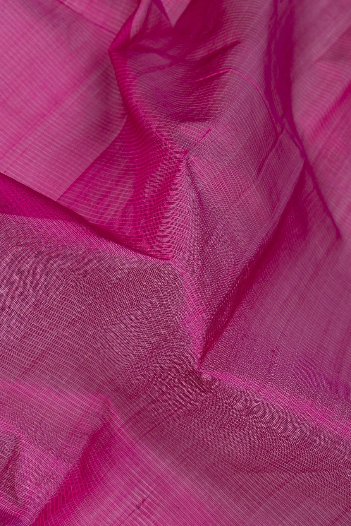 Close up of Magenta Silk Cotton Saree with Stripes on the body and Zari Border.  displaying folds