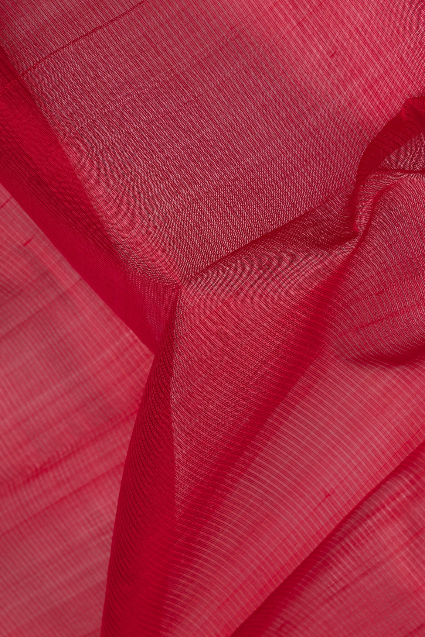 Close up of Red Silk Cotton Saree with Stripes on the body and Zari Border.  displaying folds