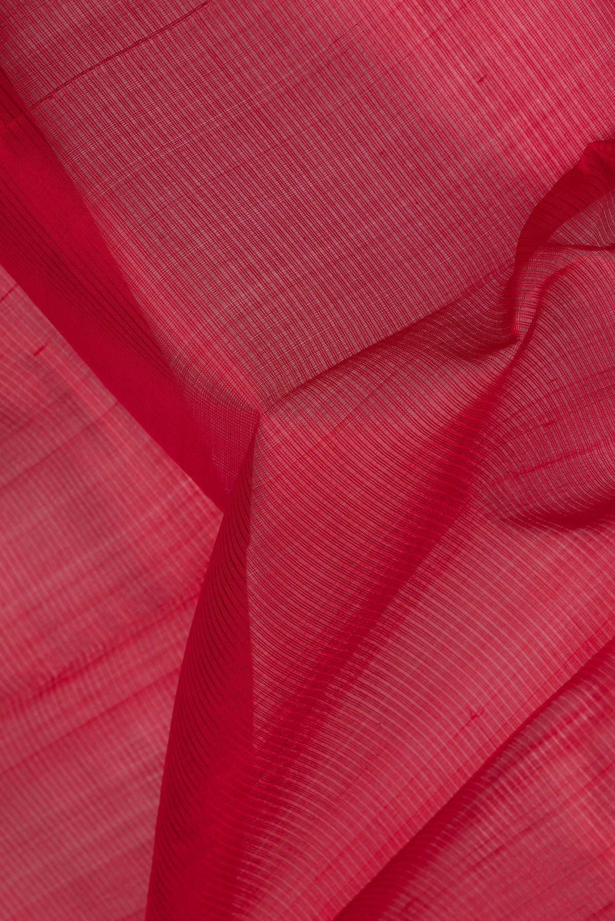 Close up of Red Silk Cotton Saree with Stripes on the body and Zari Border.  displaying folds