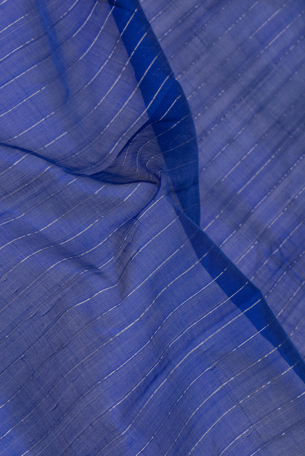 Close up of Royal Blue Silk Cotton Saree with Stripes on the body and Zari Border.  displaying folds