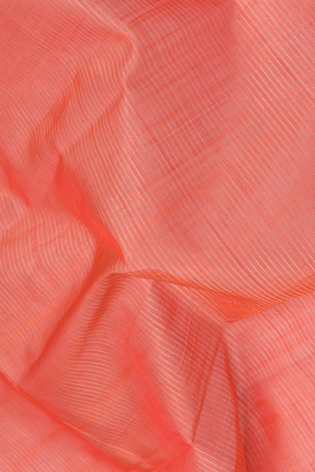 Close up of Peach Silk Cotton Saree with Stripes on the body and Zari Border.  displaying folds