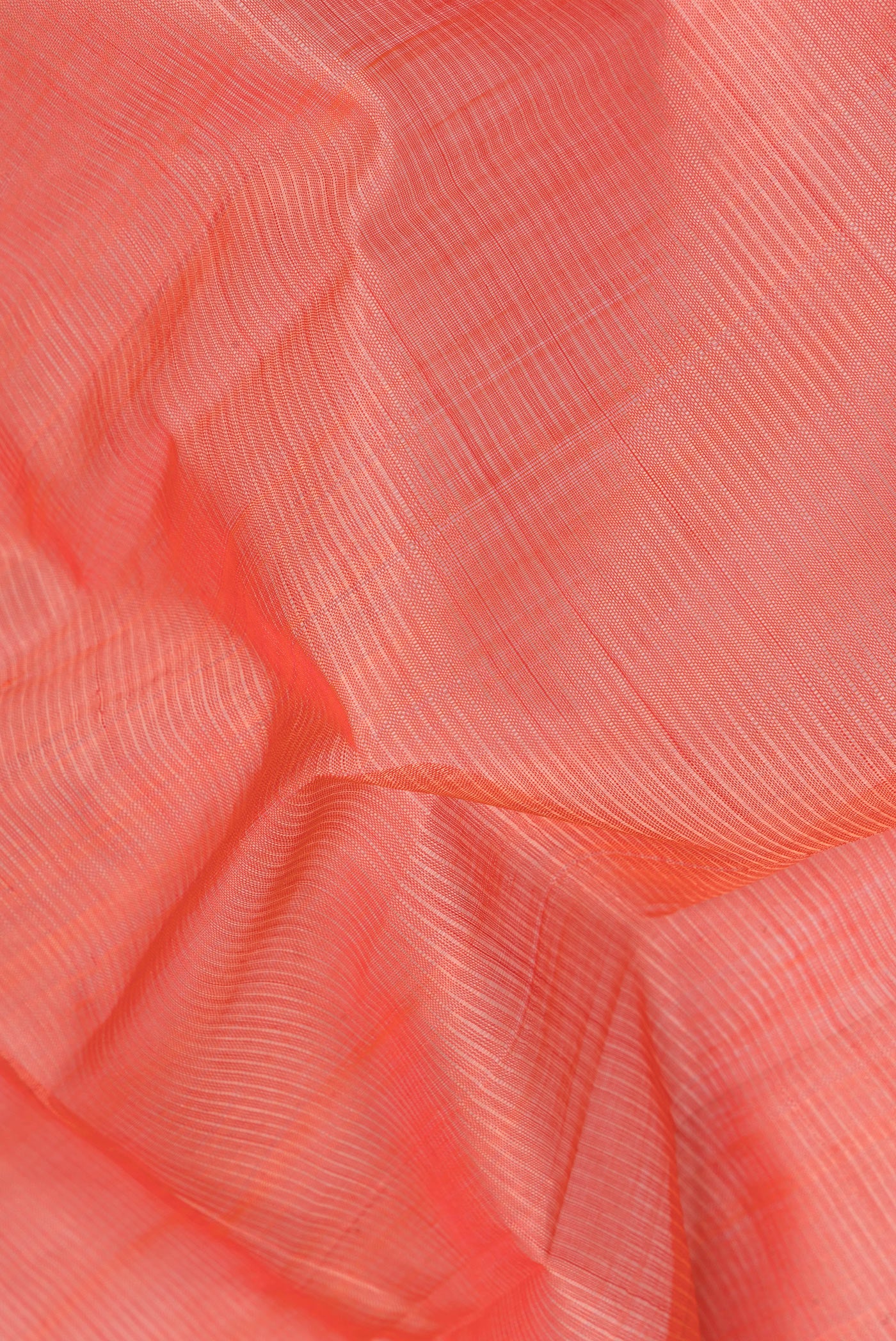 Close up of Peach Silk Cotton Saree with Stripes on the body and Zari Border.  displaying folds