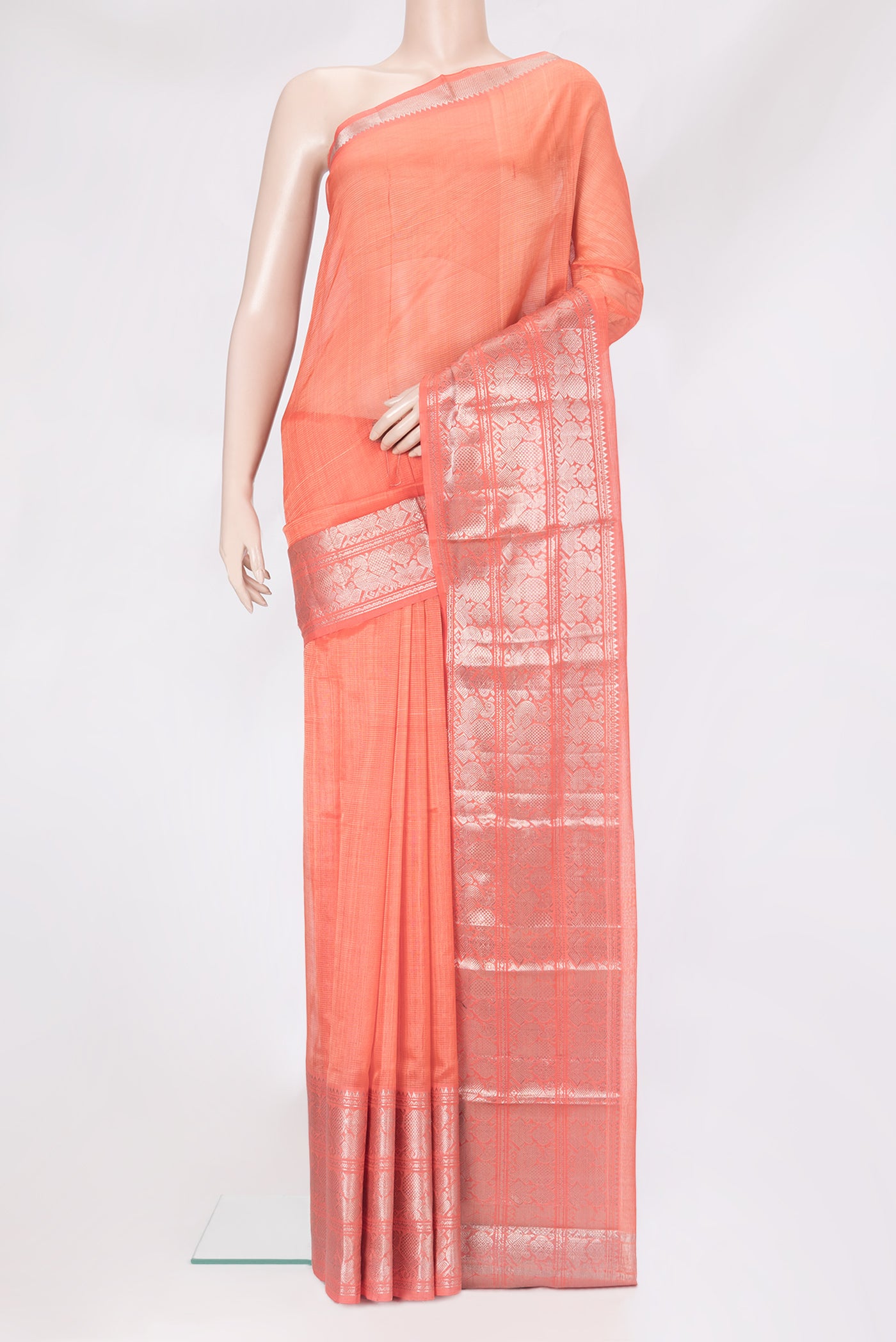 Peach Silk Cotton Saree with Stripes on the body and Zari Border.  displayed on a mannequin