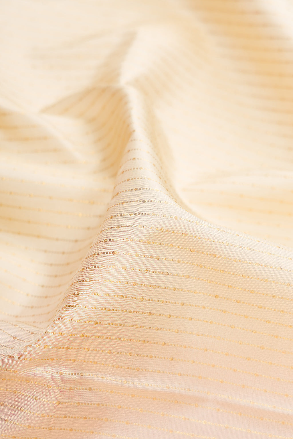 Close up of Beige Dual Tone Kanchipuram Silk Saree with Stripes on the body and Fancy Border.  displaying folds