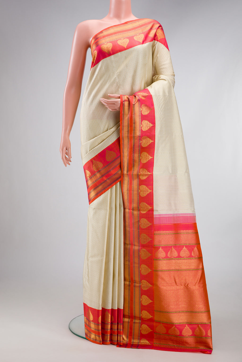 Beige Dual Tone Kanchipuram Silk Saree with Stripes on the body and Fancy Border.  displayed on a mannequin