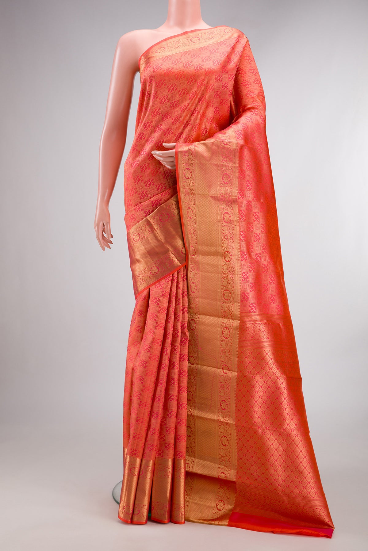 Pure Silk Brick Orange Dual Tone Kanchipuram Saree with Zari Brocade on the body and Zari Border.  displayed on a mannequin