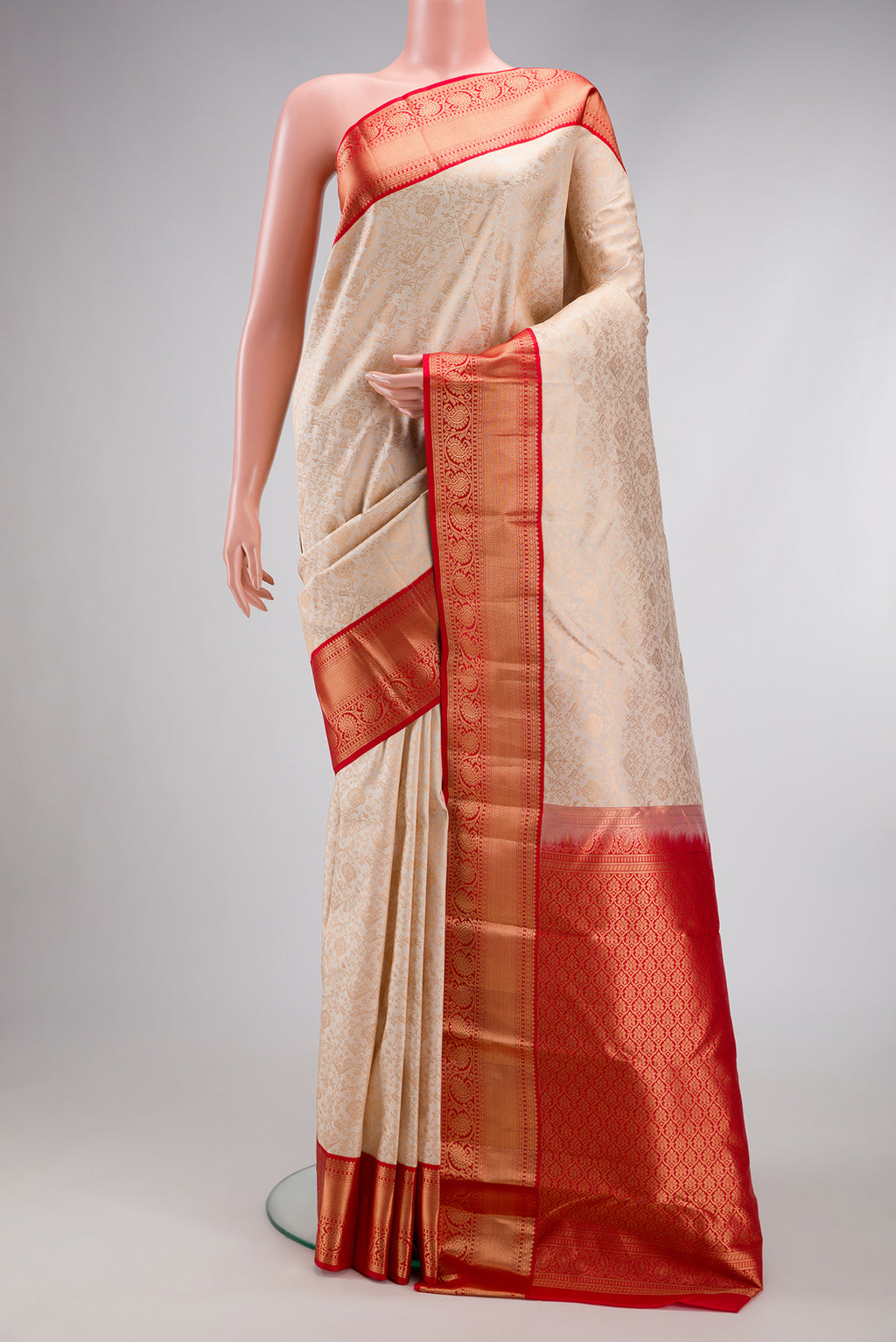 Cream Dual Tone Kanjivaram Silk Saree with Zari Brocade on the body and Zari Border.  displayed on a mannequin