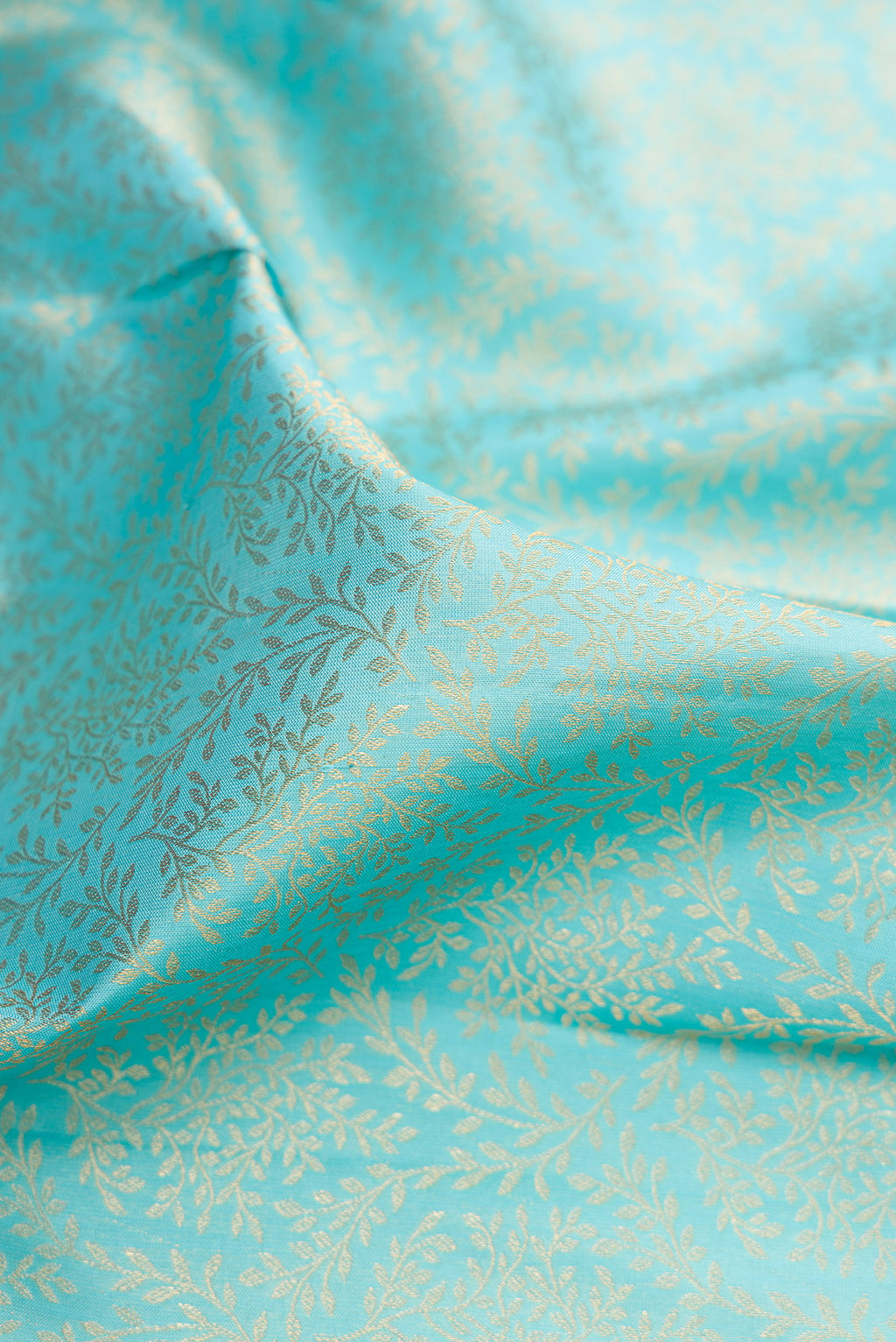Close up of Sky Blue Kanjivaram Silk Saree with Zari Brocade on the body and Zari Border.  displaying folds
