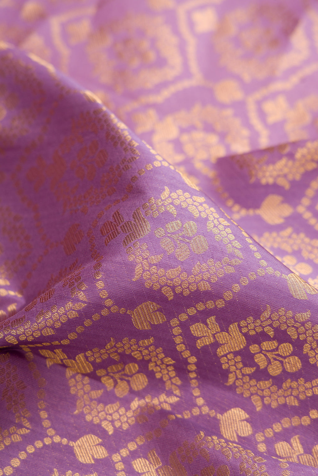 Close up of Lavender Kanjivaram Silk Saree with Zari Brocade on the body and Zari Border.  displaying folds
