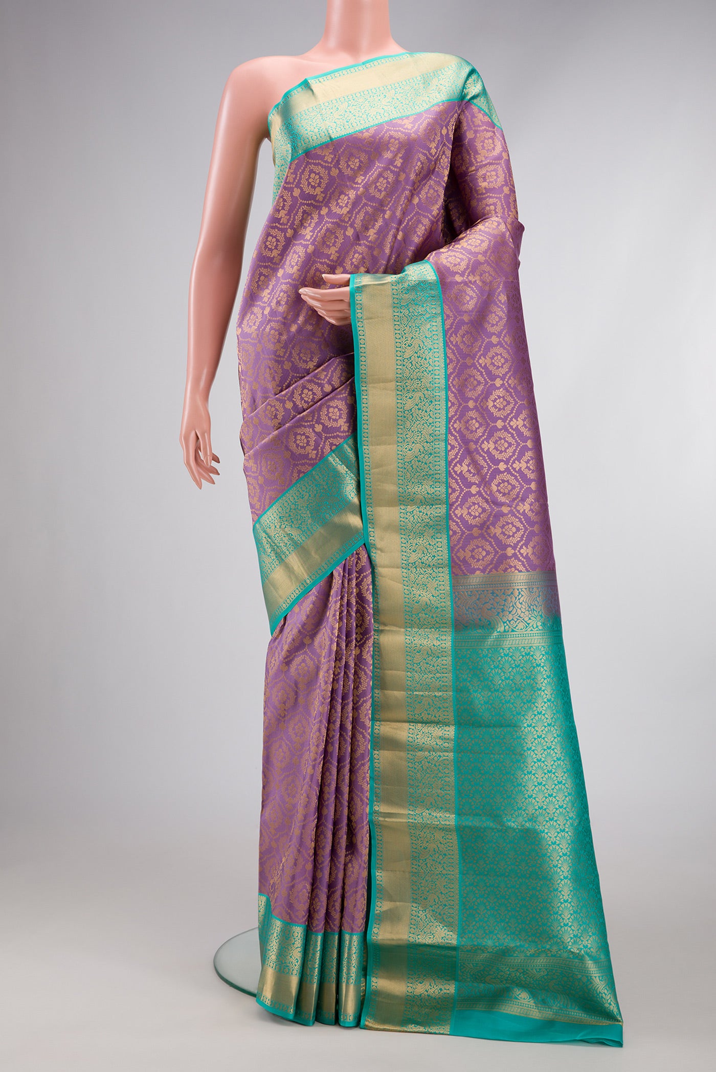 Lavender Kanjivaram Silk Saree with Zari Brocade on the body and Zari Border.  displayed on a mannequin
