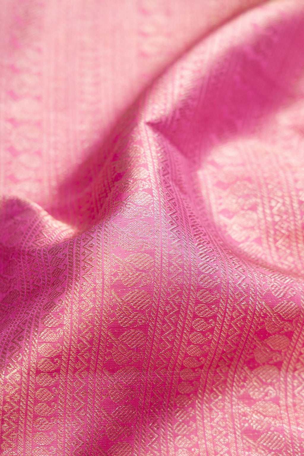 Close up of Pink Dual Tone Kanchipuram Silk Saree with Zari Brocade on the body and Zari Border.  displaying folds