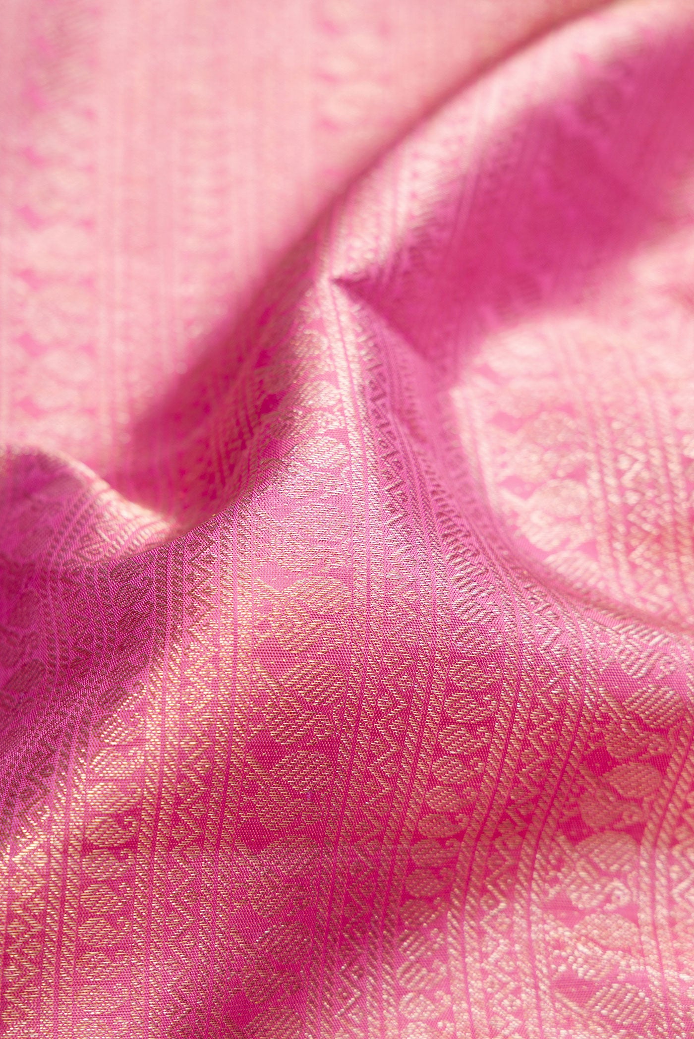 Close up of Pink Dual Tone Kanchipuram Silk Saree with Zari Brocade on the body and Zari Border.  displaying folds