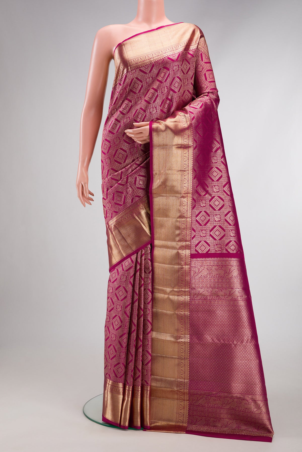 Magenta Dual Tone Kanchipuram Silk Saree with Zari Brocade on the body and Zari Border.  displayed on a mannequin