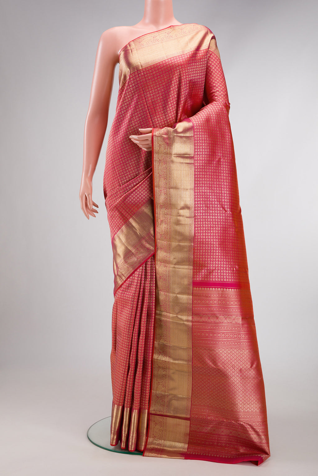 Coral Dual Tone Kanchipuram Silk Saree with Zari Brocade on the body and Zari Border.  displayed on a mannequin