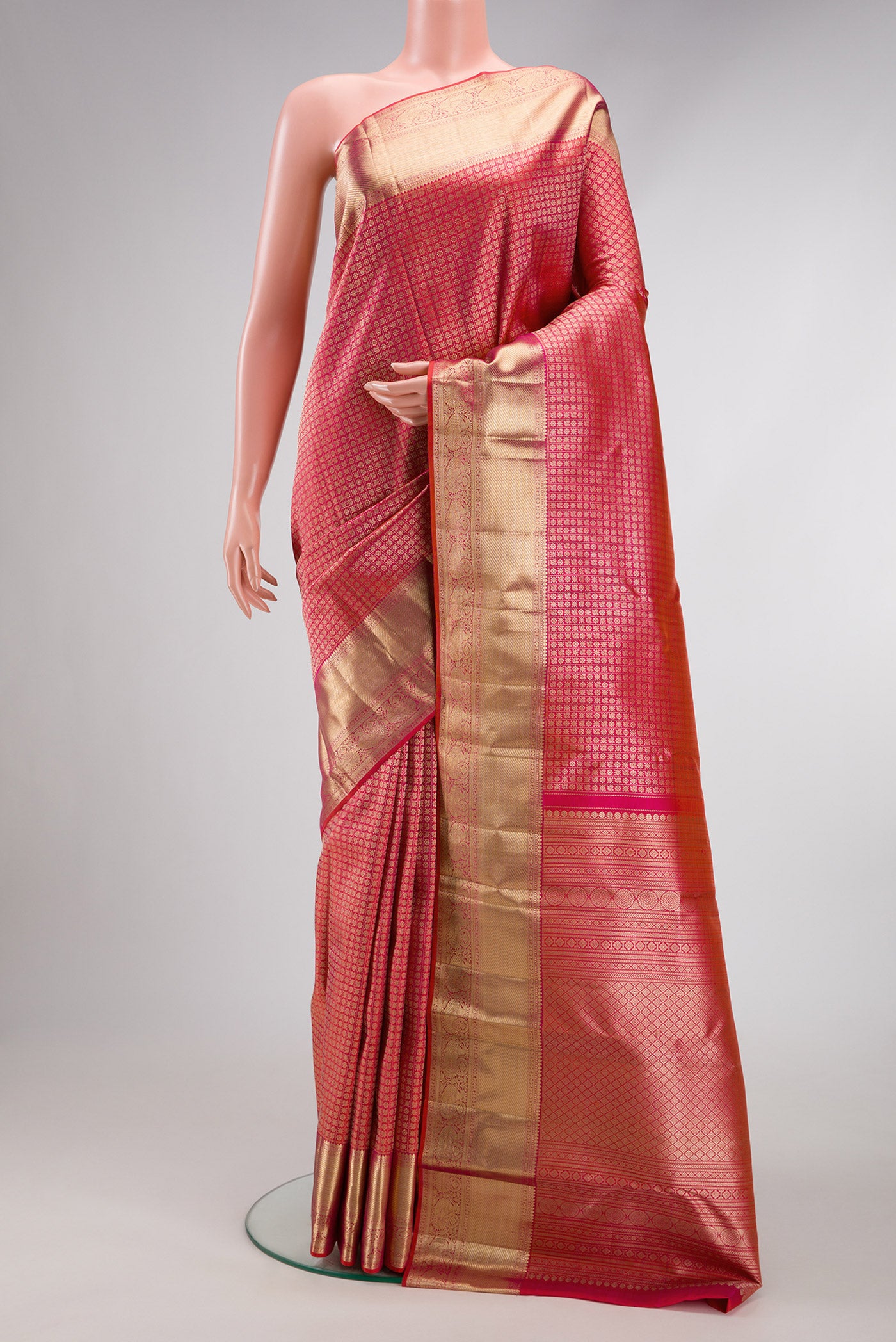 Coral Dual Tone Kanchipuram Silk Saree with Zari Brocade on the body and Zari Border.  displayed on a mannequin