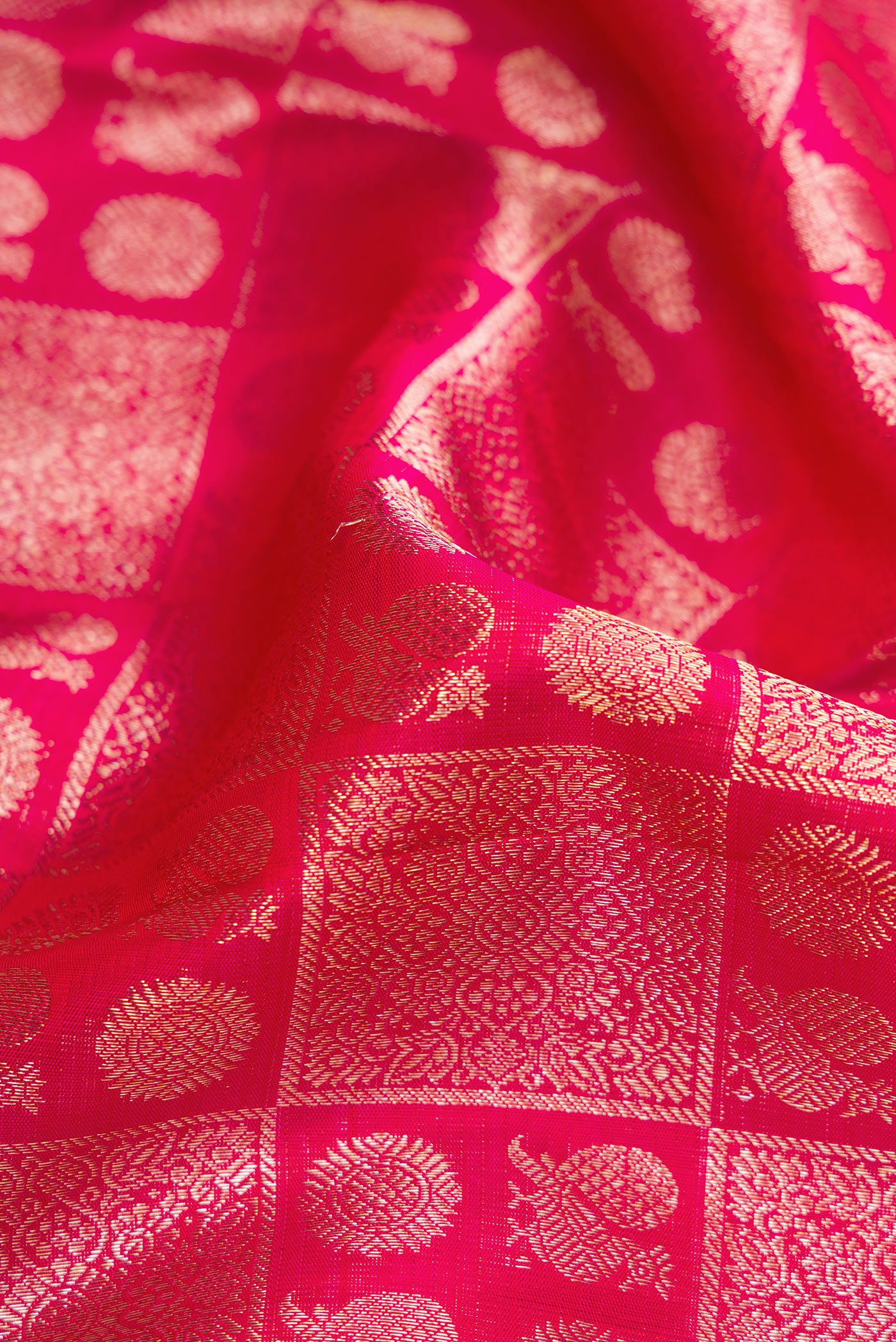 Close up of Pink Dual Tone Kanchipuram Silk Saree with Zari Brocade on the body and Zari Border.  displaying folds
