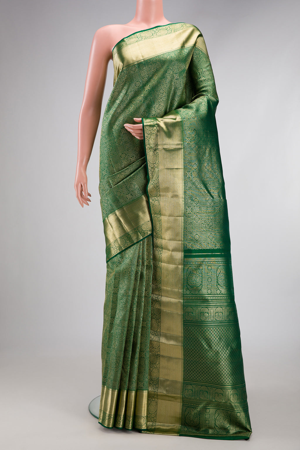 Green Kanchipuram Silk Saree with Zari Brocade on the body and Zari Border.  displayed on a mannequin