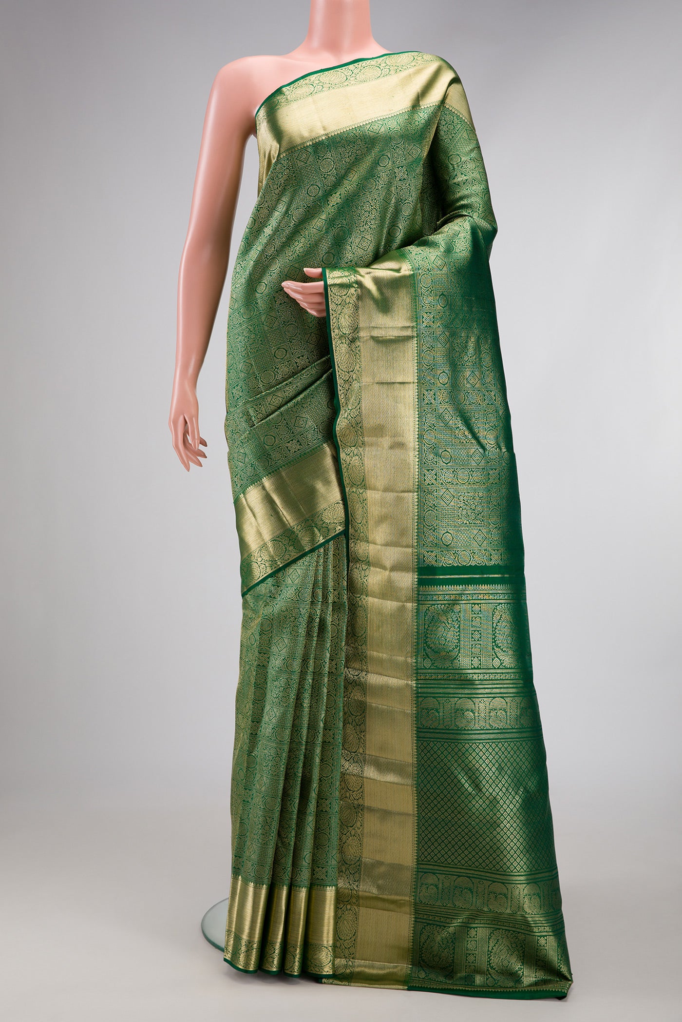 Green Kanchipuram Silk Saree with Zari Brocade on the body and Zari Border.  displayed on a mannequin