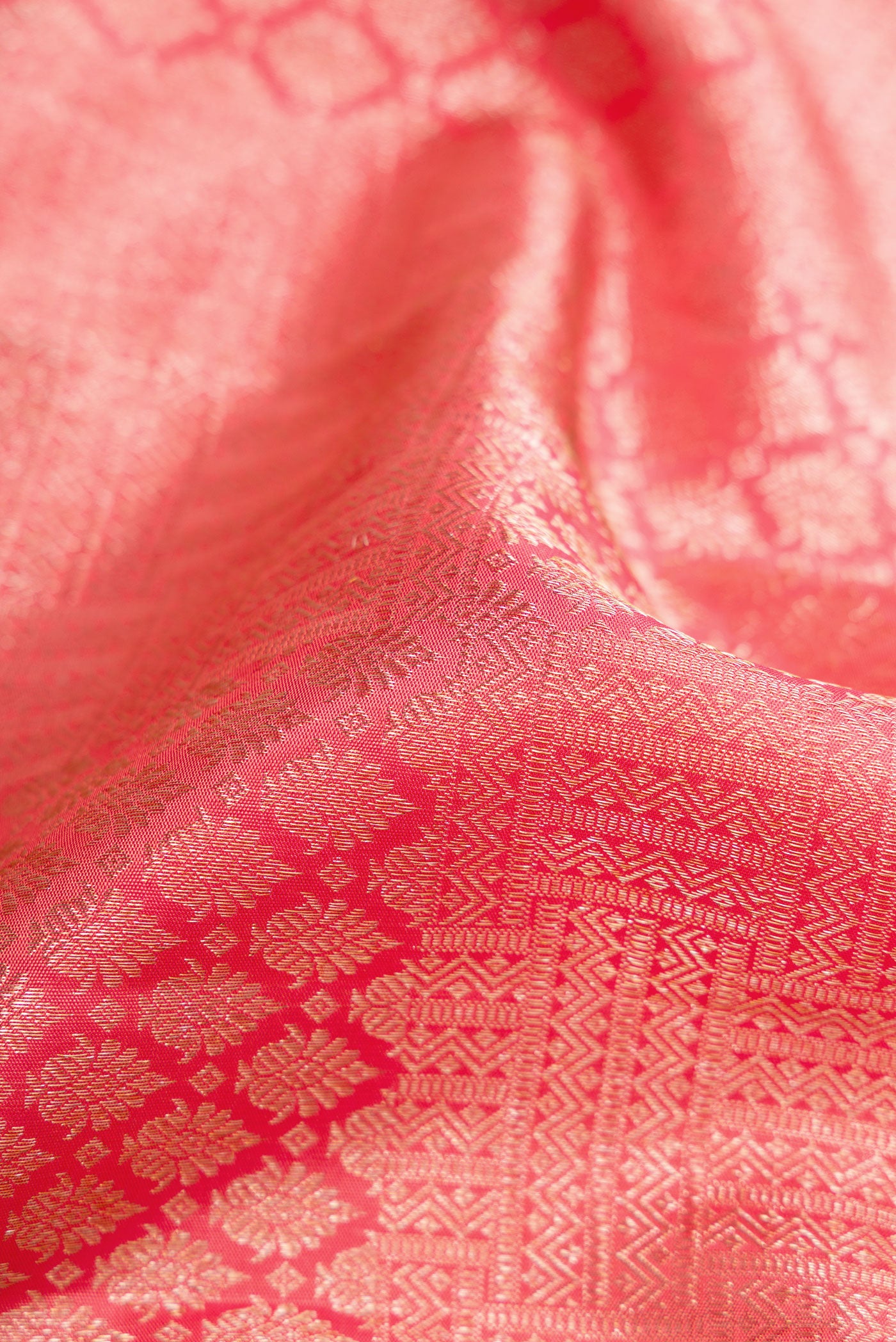 Close up of Pink Dual Tone Kanchipuram Silk Saree with Zari Brocade on the body and Zari Border.  displaying folds