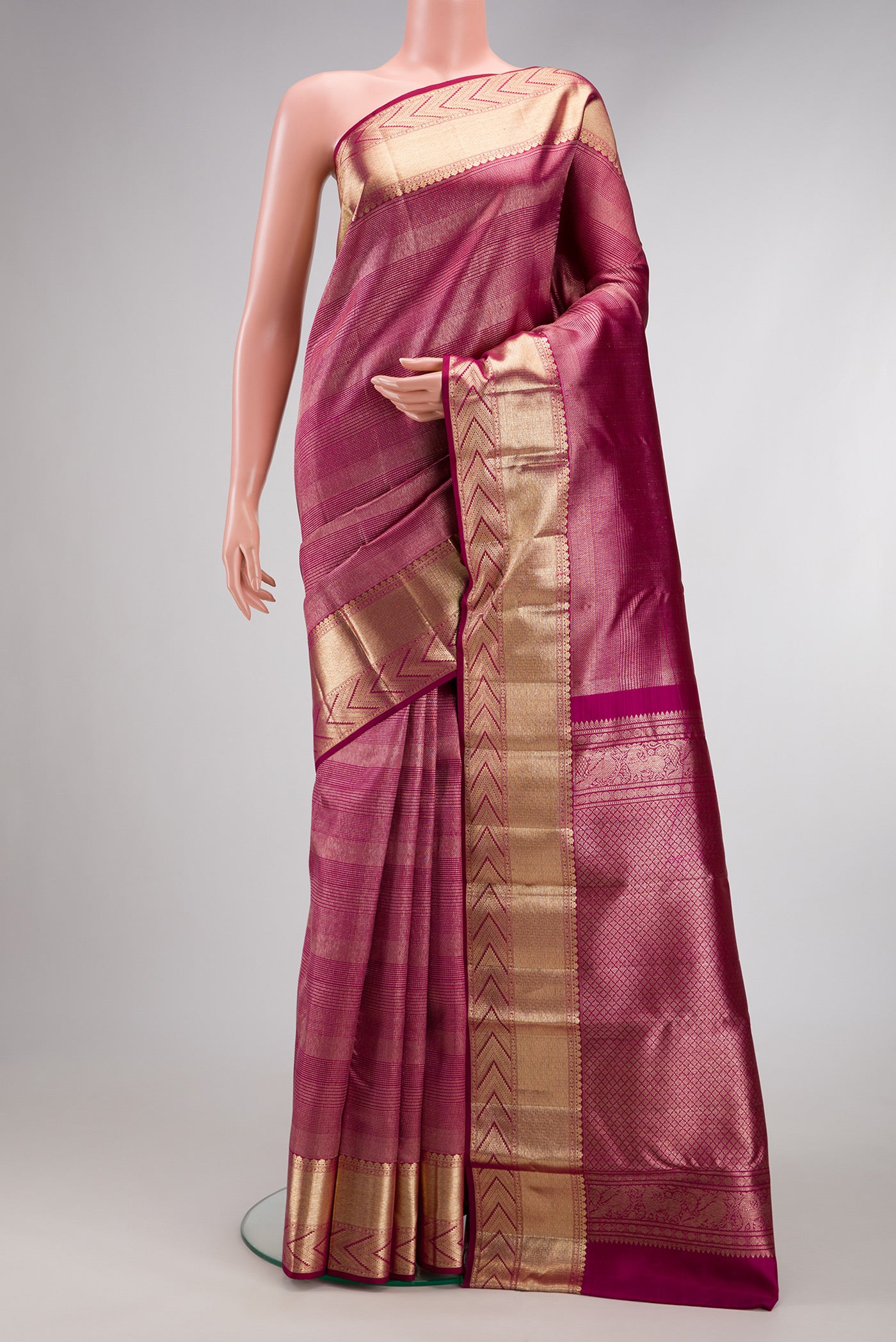 Magenta Kanchipuram Silk Saree with Zari Brocade on the body and Zari Border.  displayed on a mannequin